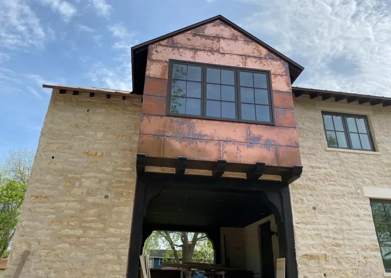 Copper metal panel facade on a stone building for Skylight Installation in New Whiteland